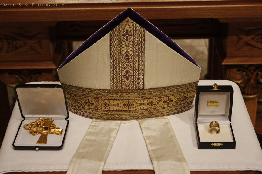 Bishop-elect Isern's pontifical insignia, left to right, pectoral cross, bishop's mitre, and ecclesial ring on display before the altar at the Cathedral of the Sacred Heart in Pueblo, CO.