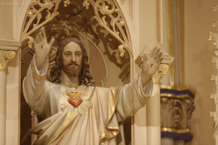 A statue of the Sacred Heart adorns high on the wall behind the altar at its namesake cathedral in Pueblo, CO.