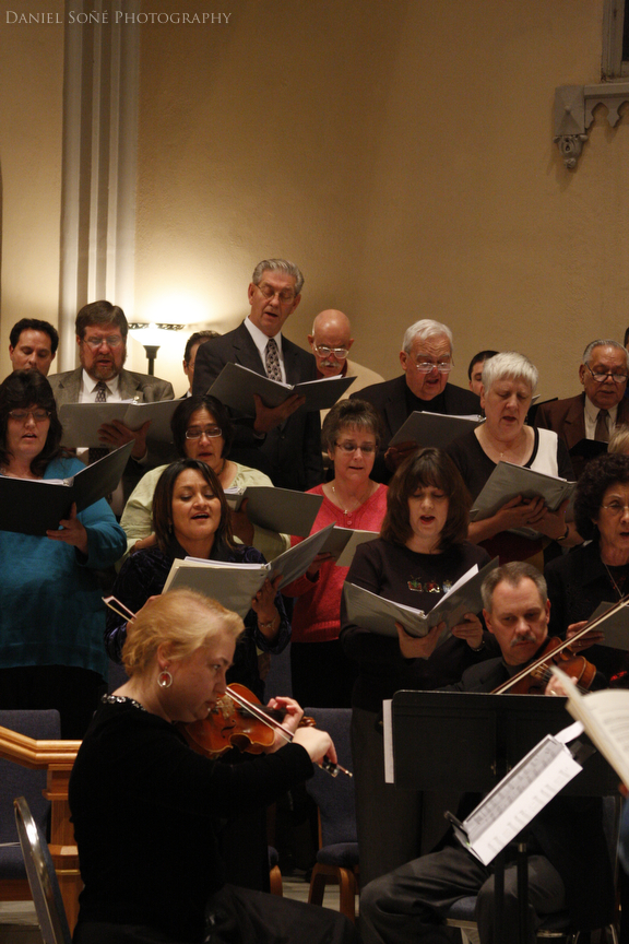 The choir singing vespers accompanied by woodwind and string instruments at Sacred Heart Cathedral in Pueblo, CO.
