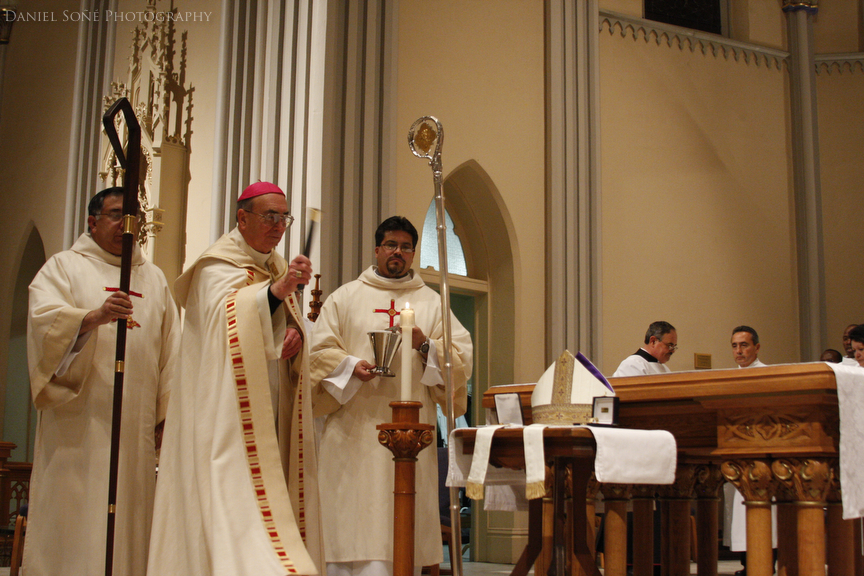 Bishop of Pueblo, Arthur N. Tafoya, blesses the crosier, mitre, ring, and pectoral cross with holy water.