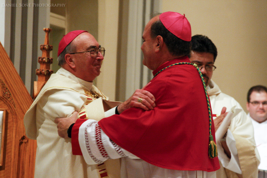 Left to right, Bishop of Pueblo, Arthur N. Tafoya, exchanges an embrace with his successor, bishop-elect Fernando Isern at the Sacred Heart Cathedral in Pueblo, CO.
