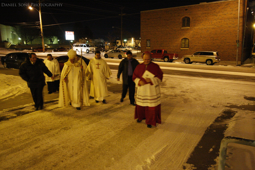 Bishop-elect Fernando Isern, center, makes his way across the icy, snowy street to the gymnasium adjacent to the Sacred Heart Cathedral after the vespers. It was approximately -15F.
