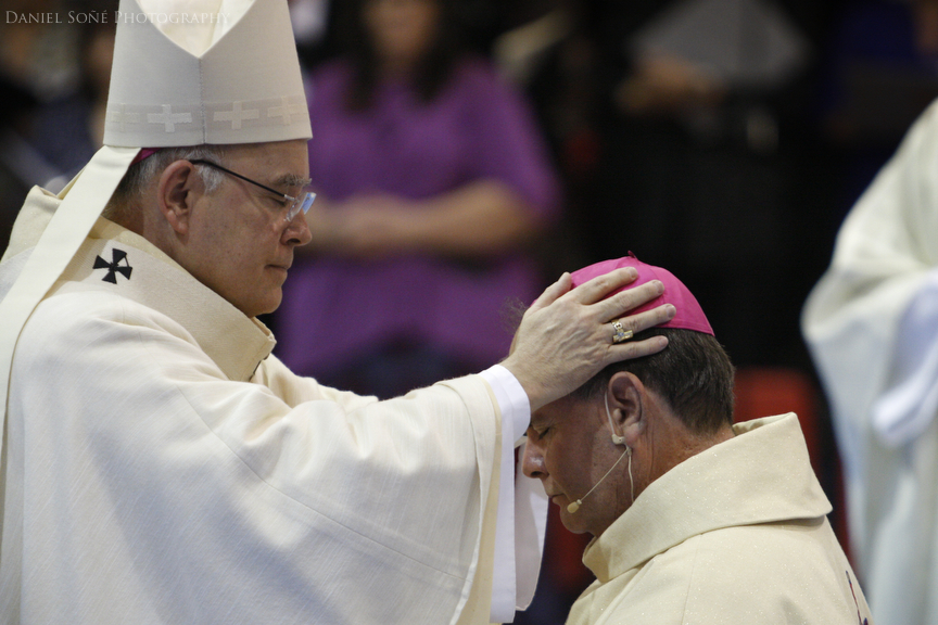 Archbishop of Denver, Charles Chaput, lays his hands upon bishop-elect Fernando Isern.