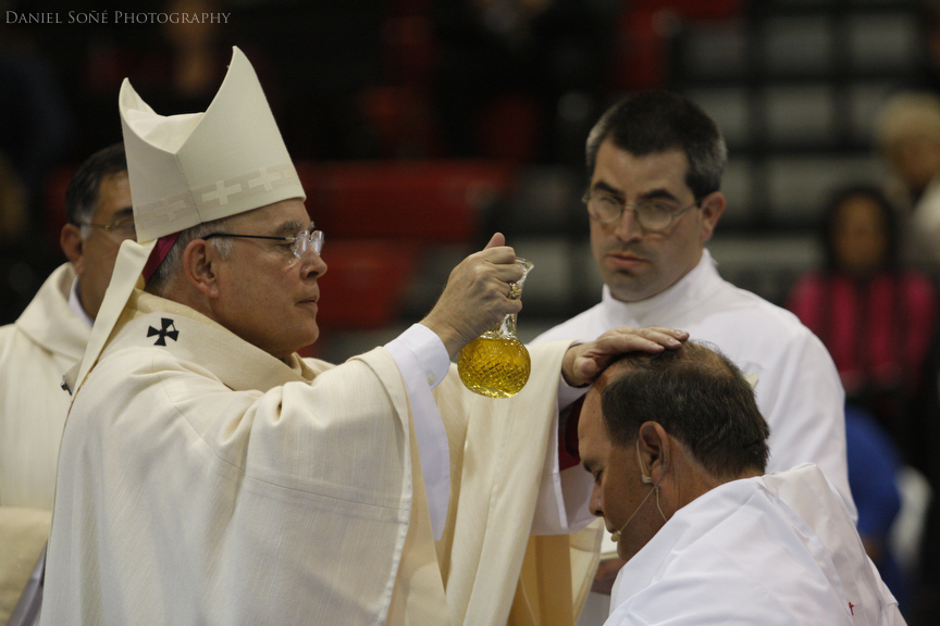 Archbishop of Denver, Charles Chaput, anoints bishop-elect Fernando Isern's head with oil.