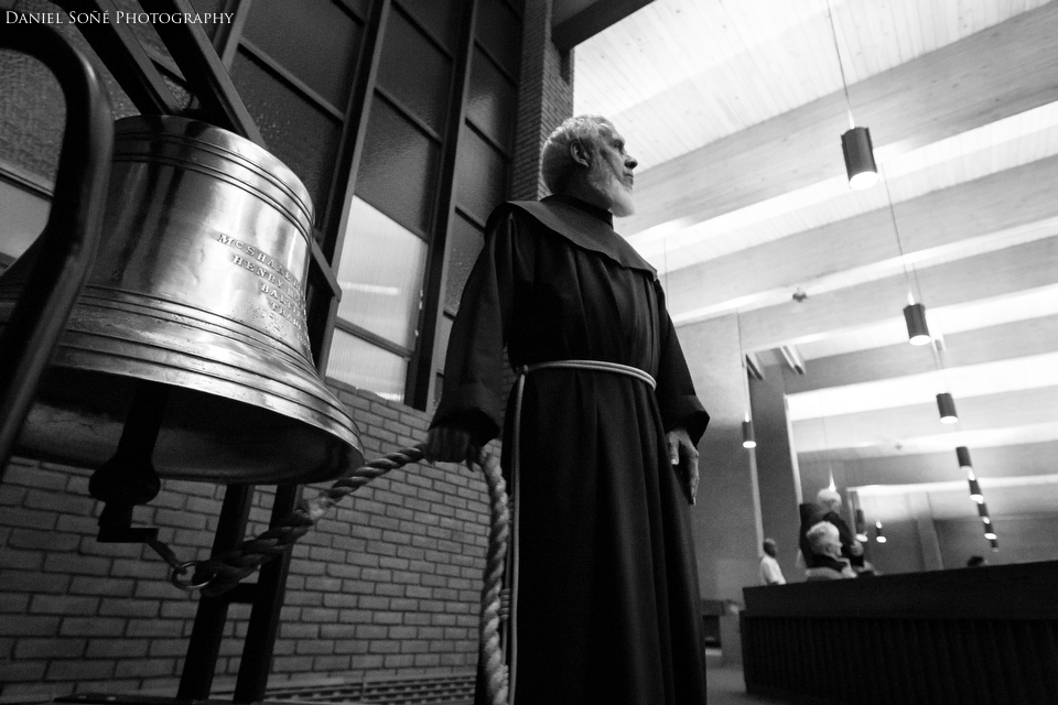  A Franciscan monk rings a large bell at the conclusion of the Transitus of St. Francis of Assisi. The transitus is essentially a funeral procession.