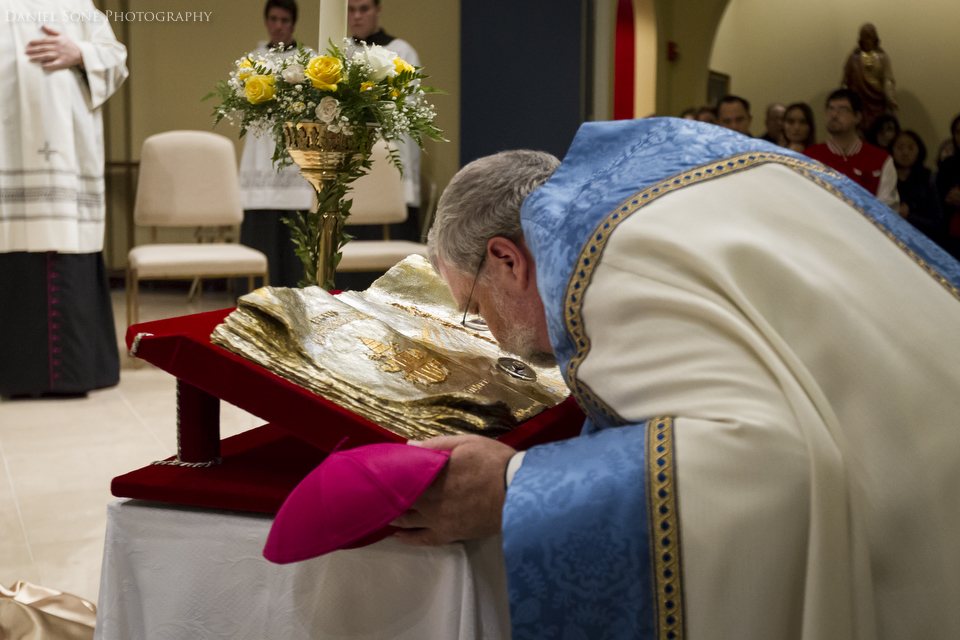 Bishop Daniel R. Jenky, C.S.C. kisses the relic of Blessed John Paul II during its final night in the Diocese of Peoria. 