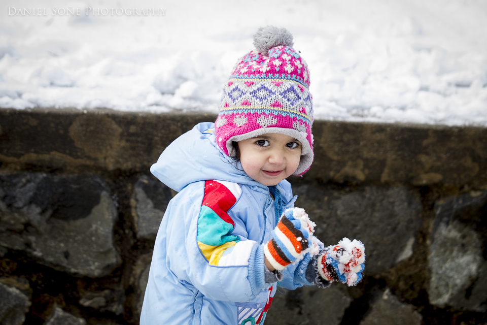 A little girl playing in the snow.