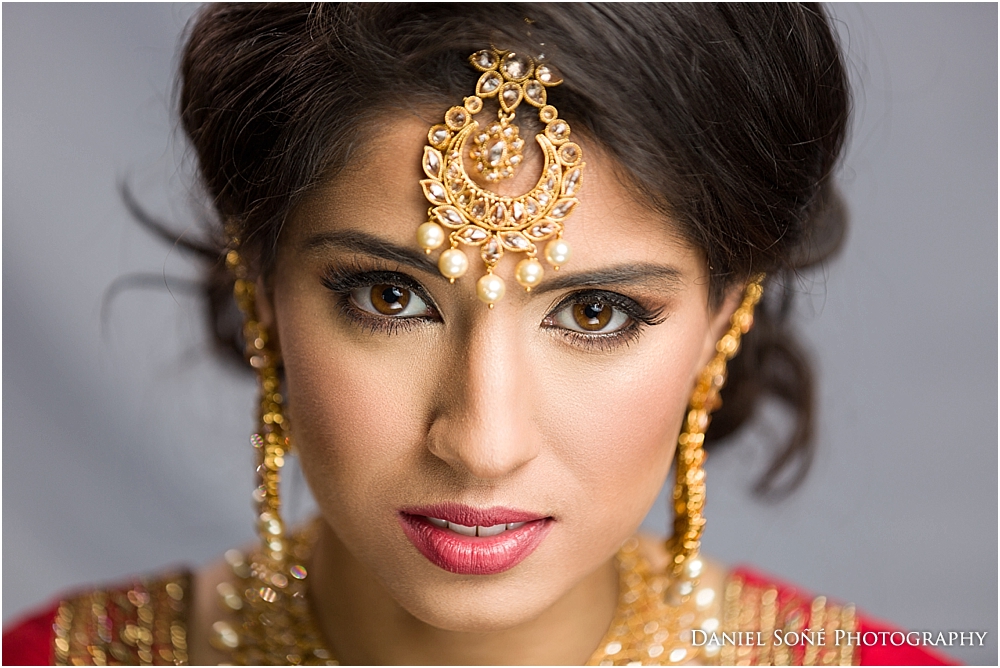 Indian wedding bride in red sari and gold tikka with pearls - MUA Glam by Jeet